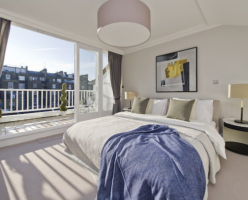 Kensington & Chelsea Property Market Report - master bedroom with view out to other houses