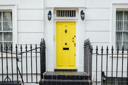 Exterior image of a property with a bright yellow door